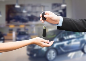 close up of customer and salesman with car key